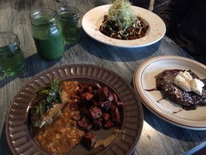 Green water, green smoothie a breakfast scramble, biscuit and gravy, sweet potatoes and a pancake  at Whyld Ass in Flagstaff