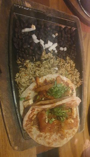Vegan Chick’n Tacos (2):
Signature tortillas filled with marinated vegan chick’n, charred tomato salsa, caramelized chipotle onions. Served with black beans & wild rice. at Nacho Daddy - Downtown in Las Vegas