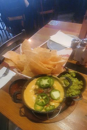 VEGAN TRIPLE DIP (GF): Guacamole, house-made vegan queso, salsa & chips. at Nacho Daddy - Downtown in Las Vegas