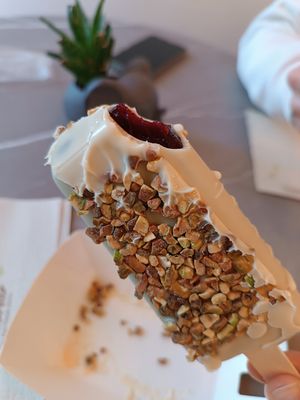 Black currant dipped it white chocolate and pistachio at Anjuna Ice Pops in Budapest