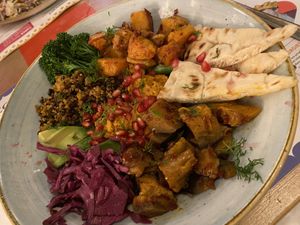Buddha Bowl with aubergine, sweet potato, quinoa, avocado, pomegranate seeds, hummus, cabbage, broccoli.  at Estadio Lounge in North West London