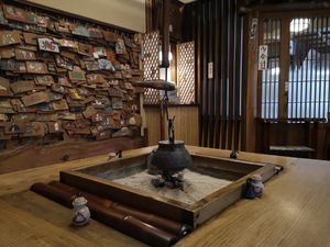 Entryway table woth votives on the wall at Shika-Jaya in Hakone