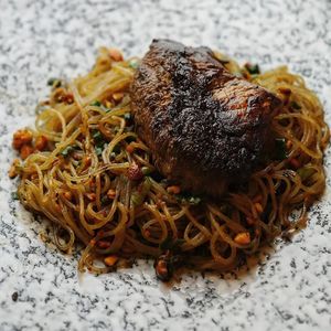 Juicy and smoky grilled Lion’s Mane with house made mushroom oyster sauce and golden sweet potato noodles at Shu in Collingwood