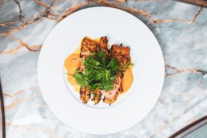 Pinchos Morunos: Turmeric grilled pork skewers, tomato pulp, cumin, garlic, lemon zest, mojo verde at Le Basque in New York City