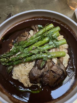 Mushroom steak with lemon orzo and asparagus.   at Le Basque in New York City