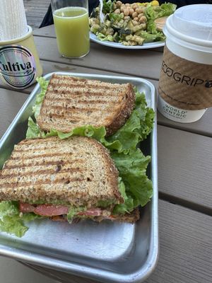 Mushroom torta on whole wheat bread, cafe de olla, super greens juice, and harvest bowl    at Cultiva  in San Juan Bautista