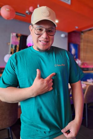 Hector sporting the branded T shirt. at Spicy Moon - Chelsea in New York City