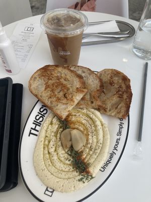 Sourdough hummus and caramel coffee with oat milkk  at Option Coffee Bar in Udon Thani