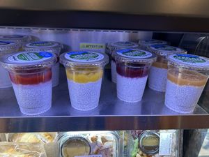 Multiple flavors of vegan chia pudding in the cold case  at Parva Coffee in Jackson Heights