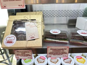 Updated prices and offerings for vegan rainbow cookies/cake  at Parva Coffee in Jackson Heights
