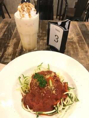 Amazing gluten free zucchini noodles with 'sausage' tomato sauce, and vegan soya caramel frappe! Really delicious food that arrives quickly, and the cafe is lovely and clean (instagram aesthetics) really worth the visit. The free wifi is fast, and all the GF options (there are a lot of them) are listed on the menu. Highly recommend  at Veganerie - Mercury Ville in Bangkok