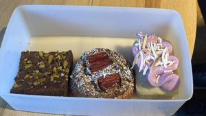 Pistachio and halva brownie, rhubarb brioche and ube and coconut cake. All amazing. You can bring  your own container.   at Better Now in Brunswick East