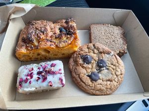 gochujang black garlic focaccia, peanut banana bread, rose cake and chocolate chip cookie at Better Now in Brunswick East
