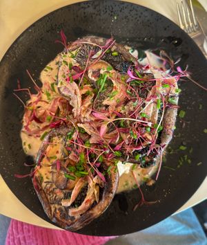 Toasted sourdough with three large flat poached mushrooms in a creamy sauce   at Coffee Woolston in Southampton