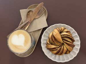 Cappuccino and cinnamon pastry  at Namo Bakery in Warsaw