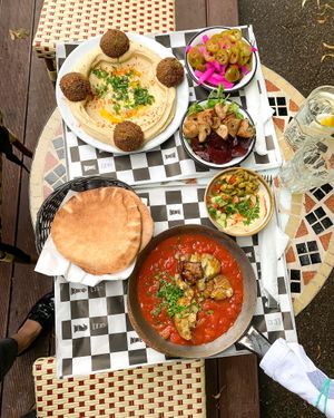 2 dishes - Shakshouka with aubergine, Hummus & falafel plate at Mezze in Warsaw