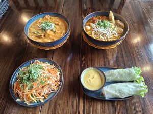 1. Fresh spring rolls, 2. Mango salad, 3. Laksa with Bún (soup with yellow curry paste, coconut milk, thin rice noodles, and toppings of soy cutlet), 4. Mỳ Vàn Thán (soup with at Metta Vegan in Warsaw