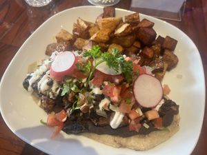 Tlacayo vegan option- double corn tortilla with beans, mushrooms seasoned pastor style with pico de gallo, vegan cheese and vegan sour cream and home fries as a side   at Camaleon in Toronto