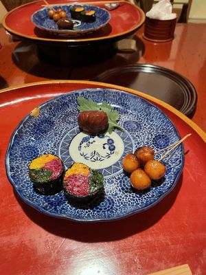Beautiful rolls of chrysanthemum petals and spinach, grilled small potatoes, and marinated chestnut   at Itosho in Tokyo