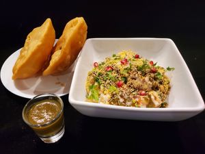 Kachori Chaat - Fried Lentil Puffs filled with potaotes, chic peas, organic yogurt and sweet/tangy sauces at Bombay Food Junkies in St Louis