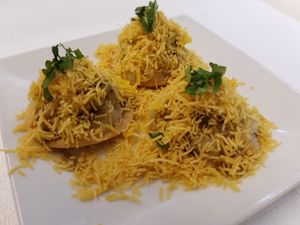Sev Puri (Chaat): Wheat crackers (puri) topped with Potatoes, Chic peas, onions, mangoes and tangy chutneys and chic pea noodles (sev) at Bombay Food Junkies in St Louis