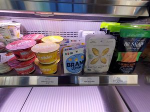 Selection of pre-packaged/on-the-go items available for purchase (including individual servings of overnight oats, beans, artichokes, carrots, pickles) at Stroll Café & Wine Bar in Portsmouth