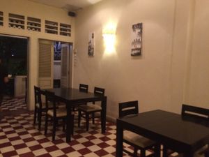 Interior seating of the Corn with two tables outside at The Corn in Phnom Penh