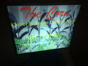 The small sign outside by the main road where you enter the alley to get to the Corn restaurant at The Corn in Phnom Penh