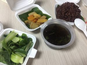 Red rice with red beans (no red beans in it), veggies and soup. Delivered at Khai Minh 2 in Ho Chi Minh City