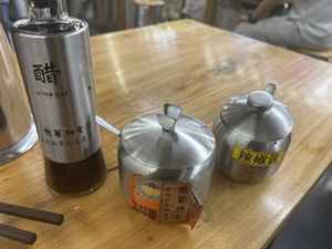 complementary sauces: vinegar, spicy mushroom sauce, chilli oil  at Longhua Temple in Shanghai