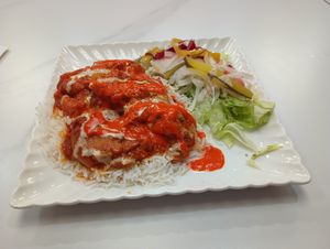 the Persian eggplant dish with rice & salad with optional drizzle of tahini & hot sauce at Ariyana in Peterborough