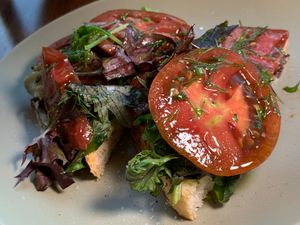Heirloom Tomato Open-Faced Sandwich: Fresh Greens, Vegan Green Goddess Mayo, Sunflower Bac'n Brittle, Chives, Toasted Italian Bread at The Sovengard in Grand Rapids