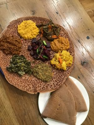A combination of collard greens, yellow split peas, whole lentils, string beans, red split peas, and beets salad. 
Our Teff injera is sour fermented like flat bread with spongy texture made  primely from teff ,an ancient grain native to Ethiopia. at Eat Today in St Louis
