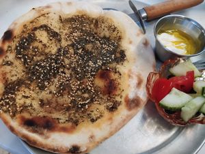 Zaatar flatbread with vegan yogurt dip and small salad at Beirutina in Sevilla