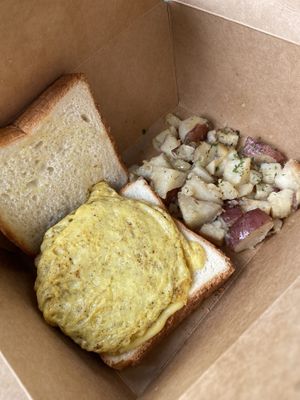 Sausage, egg and cheez on toasted bread with potatoes  at Glory Doughnuts & Diner in Frederick