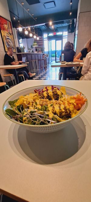 Botanical Salad: greens quinoa, avocado, root veggies, turmeric onions, red sauerkraut, peanut shoots, and saffron aioli dressing!   😋 at Le Botaniste - Penn Plaza in New York City