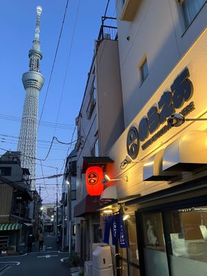 The lantern-lit exterior of Vegan Izakaya Nowhere with a view of the nearby Tokyo Skytree. at Vegan Izakaya Nowhere in Tokyo