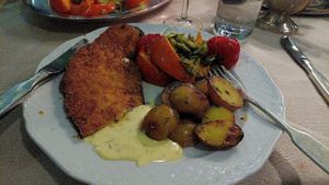 Breaded Aubergine with baked potatoes and vegetables and vegan sauce Bernaise at Gut Mönkhof in Luebeck