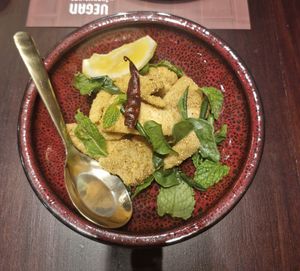 Tempura Fried Coconut Meat:
Coconut Meat, Lime, Chilli, Mint, Coriander, Kaffir Lime Leaves, Roasted Rice at Vegan Pranakhon in Bangkok