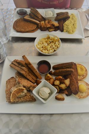 Delicious brunch at Doug's. French toast/pancakes, toast served with whipped cashew butter and maple syrup, home fries, tempeh bacon, sausages, and sunny side up vegan eggs/tofu scramble. And, as always at Doug's, served with complimentary nooch popcorn. Photo taken Nov 2016. at Doug McNish Public Kitchen in Toronto
