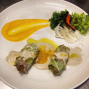 Green cabbage rolls filled with jerusalem artichokes and hazelnuts, cashew beshamel, kumquat sauce at 42 Degrés in Paris