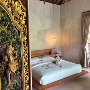 Bedroom with Balinese art at The Jungle Nook - Harmony Hill in Tampaksiring