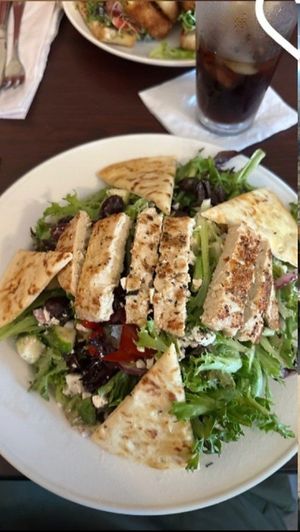 mediterranean salad with vegan chicken and feta, not featuring cut-off iced coffee and fried tofu sandwich served with cabbage slaw, seasoned fries, and a side of vegan ranch at Earth Bistro in Cleveland