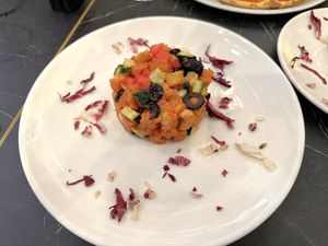 Panzanella (bred, cherry tomatoes, red onions, cucumber) with some black olives, well presented good sized serve, taste great at Alla Bracioleria Vaticano in Rome