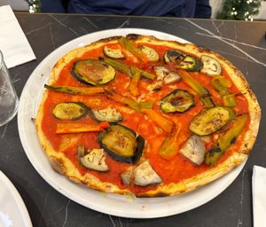Vegana Pizza with a selection of grilled aubergine/eggplant, zucchini and peppers/capsicum on a tomato sauce base with Roman style thin crust at Alla Bracioleria Vaticano in Rome