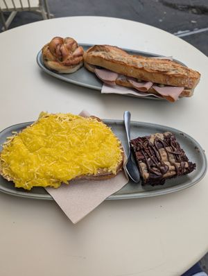 Croque Monsieur, browkie, cinnamon roll & sandwich with ham, mayo, pickle at Land & Monkeys - Les Halles in Paris