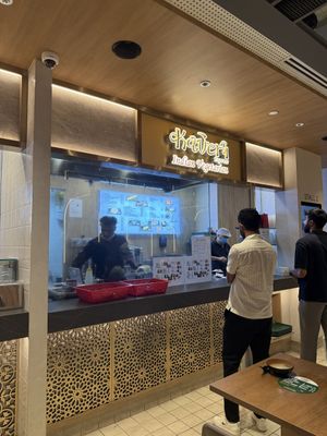 Menu identifies menu items as vegan (see the menu on the glass)  at SIN - Kaveri Express - T1 in East Singapore