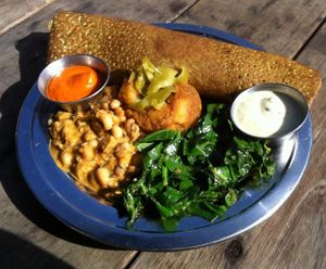 Red-lentil dosa plate- size small, $7 for happy hour! Kale-red lentil dosa, black eyed pea korma, potato masala, collards in warm dressing, pickled anaheim chilies, cilantro-lemon sauce, roasted red pepper-cashew chutney at The Sudra - 28th Ave in Portland
