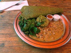 Kale Infused Dosa Plate – Kale Infused Dosa, Black Eyed Pea Korma, Potato Masala, Collards, Pickled Anaheim Chiles, Coconut Yogurt, Tomato Chutney – $12 at The Sudra - 28th Ave in Portland