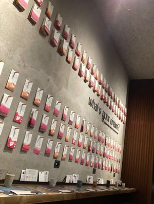The wall with all the wishes card hanging, the table towards the wall  at Yume Ramen in Rimini